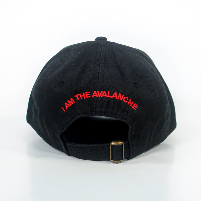 A black dad hat by I Am The Avalanche, shown from the back, features red “I AM THE AVALANCHE” text above an adjustable strap with a brass buckle.