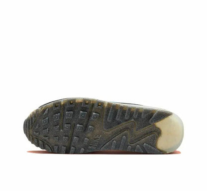 Nike Air Max 90 outsole with dark tread and tan edge, sneaker bottom view