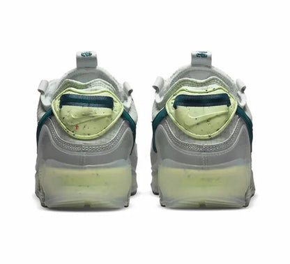 Air Max 90 sneakers back view, white uppers with teal heel detail and lime midsole