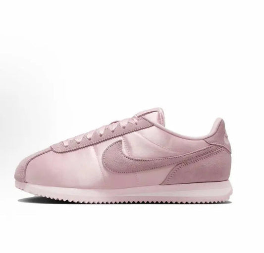 Pink Nike Cortez low-top sneakers with suede overlays and Swoosh logo
