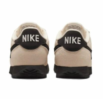 Nike Cortez sneakers heel view: NIKE logo on black heel counter