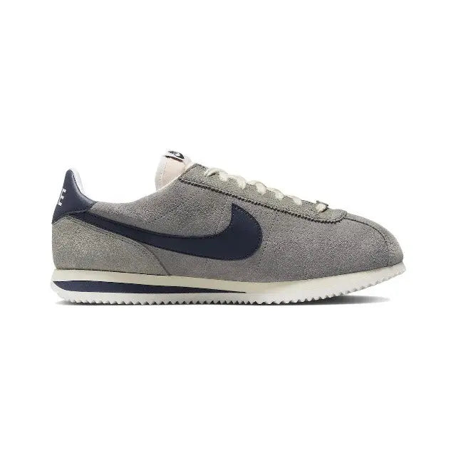 Grey Nike Cortez low-top sneakers with navy swoosh and lace-up details