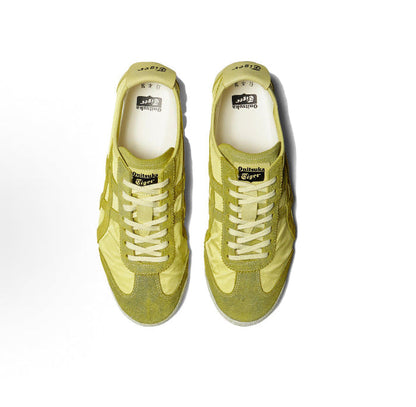 Pair of light chartreuse low-top sneakers with lace-up front and textured side panels