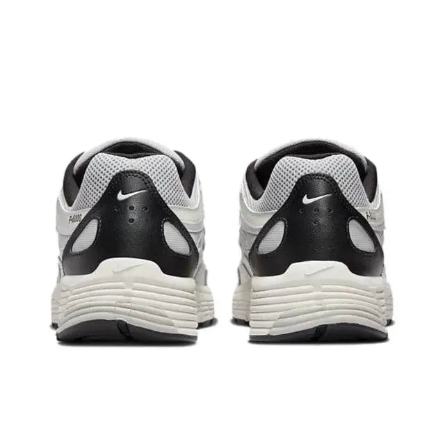 Back view white-and-black Nike running sneaker with black heel collar