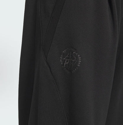 Black track pants with embossed adidas mark on side panel